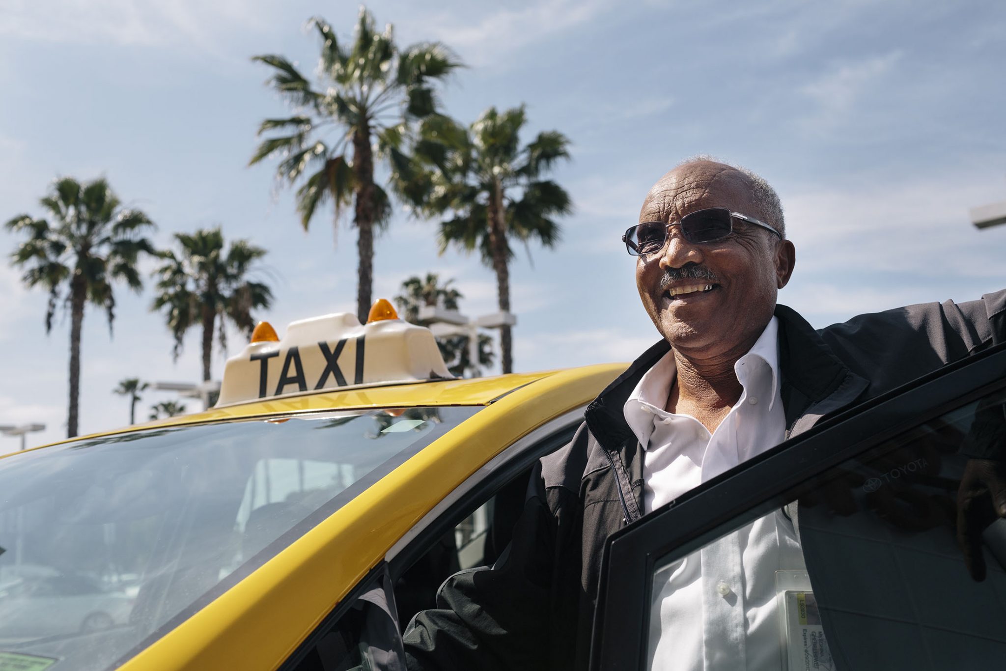 Mesghina Ghebrehiwat, 70, who goes by the name Alex, is the owner of Friendly Cab in San Diego. Ghebrehiwat, originally from Eritrea, has been driving at taxi in San Diego for 14 years and was an early adopter of switching to a hybrid vehicle in 2012 because of incentives offered by Mossy Toyota. Mossy offered the San Diego taxi drivers zero down and low or no interest financing, driver discounts, free carwashes and preferred service if they would switch to driving a Prius.